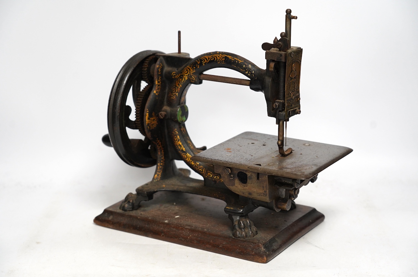 A late 19th century The Royal Sewing machine Co Shakespeare sewing machine, on a mahogany base with gilt decoration to the frame. Condition - fair